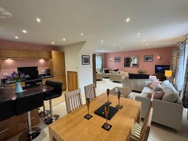 A dining area and living room with furniture at River Tamar Couples Retreat Dog Friendly in Newbridge