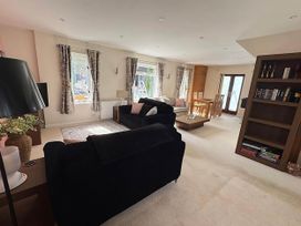 A living room with a sofa and dining area at River Tamar Couples Retreat Dog Friendly in Newbridge