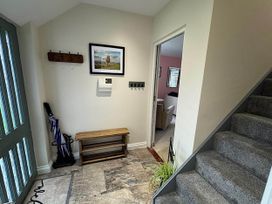 A hallway with a coat rack and bench at River Tamar Couples Retreat Dog Friendly Newbridge