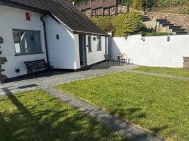 A garden with a bench and chairs at River Tamar Couples Retreat Dog Friendly Newbridge