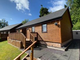 A log cabin with steps and a deck at Blairgowrie Luxury 3 Bed Lodge with Hot Tub, Blairgowrie