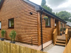 A log cabin with windows and decking at Blairgowrie Luxury 3 Bed Lodge with Hot Tub, Blairgowrie