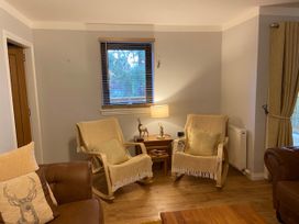 A living room with rocking chairs and a coffee table at Blairgowrie Luxury 3 Bed Lodge with Hot Tub in Blairgowrie