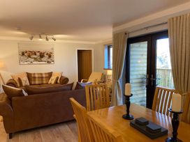 A living room with a sofa and dining table at Blairgowrie Luxury 3 Bed Lodge with Hot Tub in Blairgowrie
