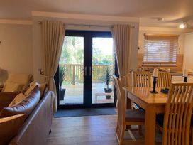 A living room with a dining area and access to a deck at Blairgowrie Luxury 3 Bed Lodge with Hot Tub in Blairgowrie