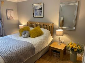 A bedroom with a bed and lamp at Blairgowrie Luxury 3 Bed Lodge with Hot Tub in Blairgowrie