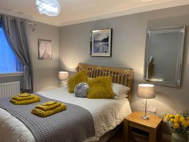 A bedroom with a bed and nightstand at Blairgowrie Luxury 3 Bed Lodge with Hot Tub in Blairgowrie