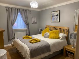 A bedroom with a bed, pillows, and a nightstand at Blairgowrie Luxury 3 Bed Lodge with Hot Tub, Blairgowrie