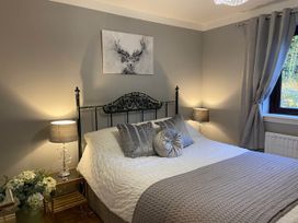 A bedroom with a bed and a picture on the wall at Blairgowrie Luxury 3 Bed Lodge with Hot Tub, Blairgowrie
