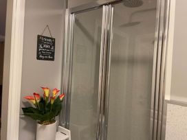 A bathroom with a shower and a flower pot at Blairgowrie Luxury 3 Bed Lodge with Hot Tub, Blairgowrie