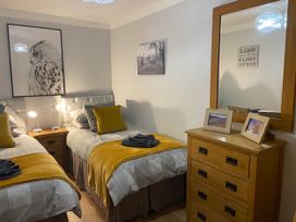 A bedroom with two beds and a mirror at Blairgowrie Luxury 3 Bed Lodge with Hot Tub in Blairgowrie