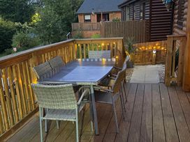 An outdoor dining area with a table and chairs at Blairgowrie Luxury 3 Bed Lodge with Hot Tub in Blairgowrie