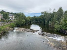 A river with a waterfall and trees at Blairgowrie Luxury 3 Bed Lodge with Hot Tub Blairgowrie