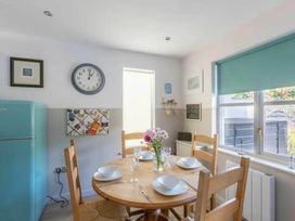A dining room with a table and chairs at 2 Bedrooms overlooking Little Petherick Creek Little Petherick
