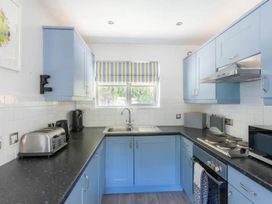 A kitchen with cabinets and appliances at 2 Bedrooms overlooking Little Petherick Creek Little Petherick