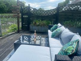 An outdoor area with a couch and coffee table at 2 Bedrooms overlooking Little Petherick Creek in Little Petherick