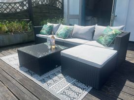 An outdoor seating area with a sofa and coffee table at 2 Bedrooms overlooking Little Petherick Creek Little Petherick