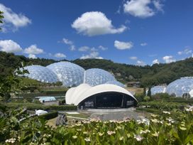 An outdoor stage with geodesic domes at Eden Sessions in Cornoweth