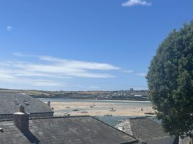 A view of boats in water with rooftops and a tree at 2 Bedrooms overlooking Little Petherick Creek Little Petherick