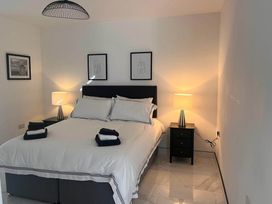 A bedroom featuring a double bed with nightstands and lamps at Sunset Cottage Sleeps 6 with Parking Garden in Magilligan near Limavady