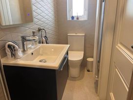 A bathroom with a sink and toilet at Sunset Cottage Sleeps 6 with Parking Garden Magilligan near Limavady