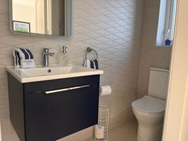 A bathroom with sink and toilet at Sunset Cottage Sleeps 6 with Parking Garden in Magilligan near Limavady
