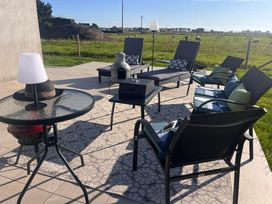 A seating area with chairs and table at Sunset Cottage Sleeps 6 with Parking Garden in Magilligan near Limavady