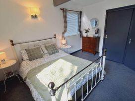 A bedroom with a bed, bedside table, and chest of drawers at Forest Retreat Sleeps 4 2Bed with Parking Woolsery near Bideford
