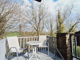 An outdoor area with a table and chairs at Forest Retreat Sleeps 4 2Bed with Parking Woolsery near Bideford