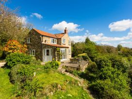 A cottage with a garden and patio at Stunning 3 Bedroom Cottage near Historic York, Ampleforth