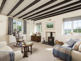 A living room with a chair and table at Stunning 3 Bedroom Cottage near Historic York in Ampleforth