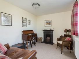 A living room with a sofa and piano at Stunning 3 Bedroom Cottage near Historic York in Ampleforth