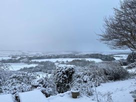 A snowy landscape with trees and bushes at Stunning 3 Bedroom Cottage near Historic York in Ampleforth