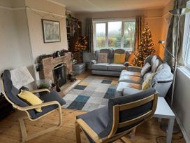 A living room with a fireplace and Christmas tree at House Sleeps 8 Close to Beach Free parking in Mullion
