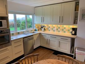 A kitchen with cabinets and appliances at House Sleeps 8 Close to Beach Free parking, Mullion