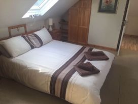 A bedroom with a bed and bedside lamp at House Sleeps 8 Close to Beach Free parking in Mullion