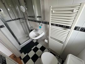 A bathroom with a sink and shower at House Sleeps 8 Close to Beach Free parking in Mullion