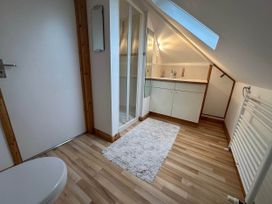 A bathroom with a sink, shower, and toilet at House Sleeps 8 Close to Beach Free parking, Mullion