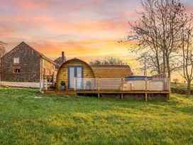 A wooden cabin with a hot tub and decking at The Lodge at Brambles Farm Sleeps 4 Hot Tub in Leek