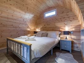 A bedroom with a bed and bedside table at The Lodge at Brambles Farm Sleeps 4 Hot Tub in Leek