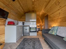 A kitchen with a sofa and appliances at The Lodge at Brambles Farm Sleeps 4 Hot Tub in Leek