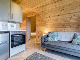 A kitchen area with a fridge and oven at The Lodge at Brambles Farm Sleeps 4 Hot Tub in Leek