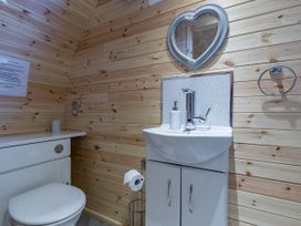 A bathroom with a sink and toilet at The Lodge at Brambles Farm Sleeps 4 Hot Tub in Leek