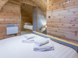 A bedroom with bed and heater at The Lodge at Brambles Farm Sleeps 4 Hot Tub Leek