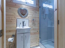 A bathroom with a sink and shower at The Lodge at Brambles Farm Sleeps 4 Hot Tub Leek