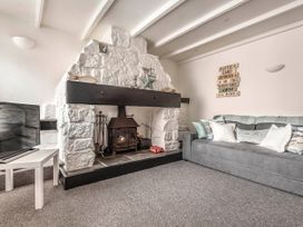 A living room with a fireplace and a sofa at Cottage Sleeps 6 Pet friendly Patio in Saint Austell