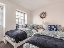 A bedroom with two beds and a nightstand at Cottage Sleeps 6 Pet friendly Patio in Saint Austell