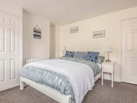 A bedroom with a bed and bedside table at Cottage Sleeps 6 Pet friendly Patio in Saint Austell