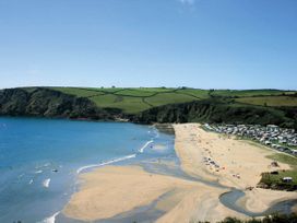 A beach with tents and cars at Cottage Sleeps 6 Pet friendly Patio in Saint Austell
