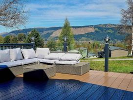 An outdoor seating area with cushions and a coffee table at Dunoon 3Bed Lodge Sleeps 6 Pet Friendly near Dunoon